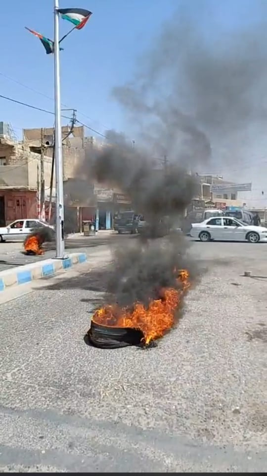 مسرّحون من العمل يغلقون طريق ذيبان الرئيسي بالاطارات المشتعلة - صور