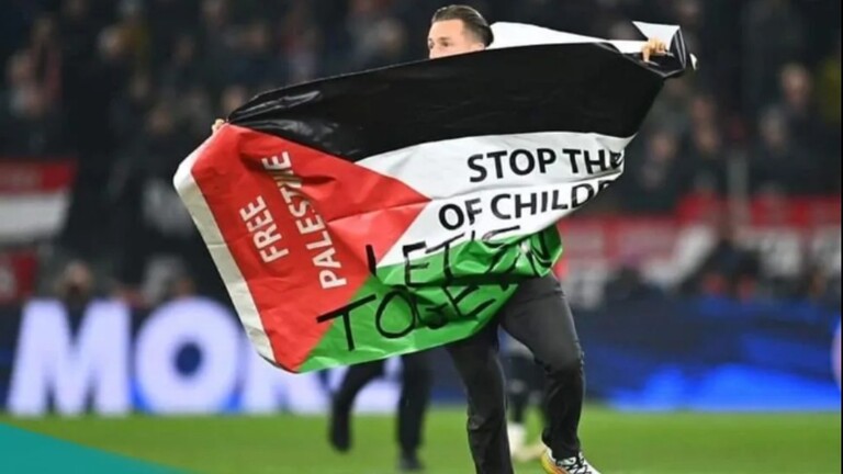 لحظة اقتحام مشجع ملعب مباراة في دوري أبطال أوروبا يرفع علم فلسطين